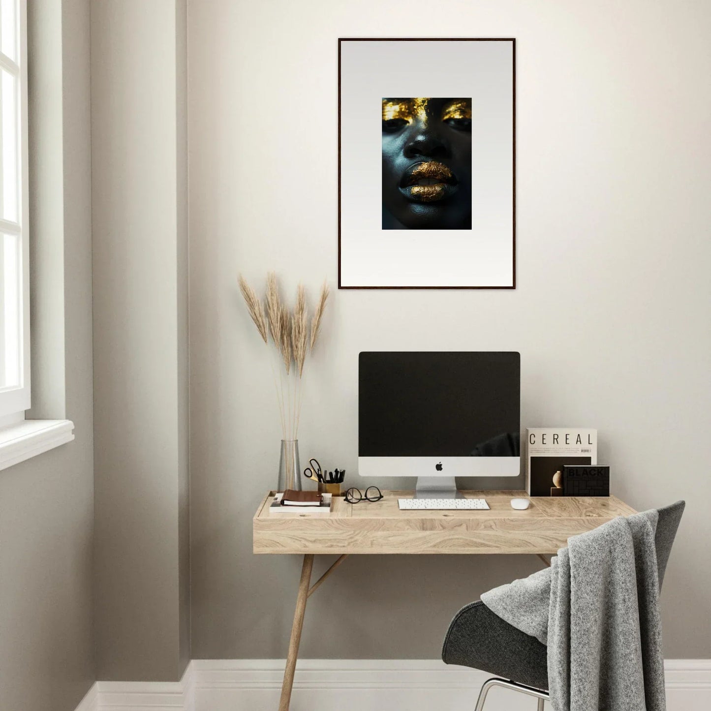 Minimalist home office with wooden desk, computer, and Star Riot canvas print