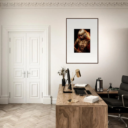 Elegant home office with a wooden desk, framed artwork, and ornate white door.