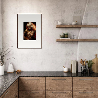 Modern kitchen with wooden cabinets, stone countertop, and framed artwork on the wall.