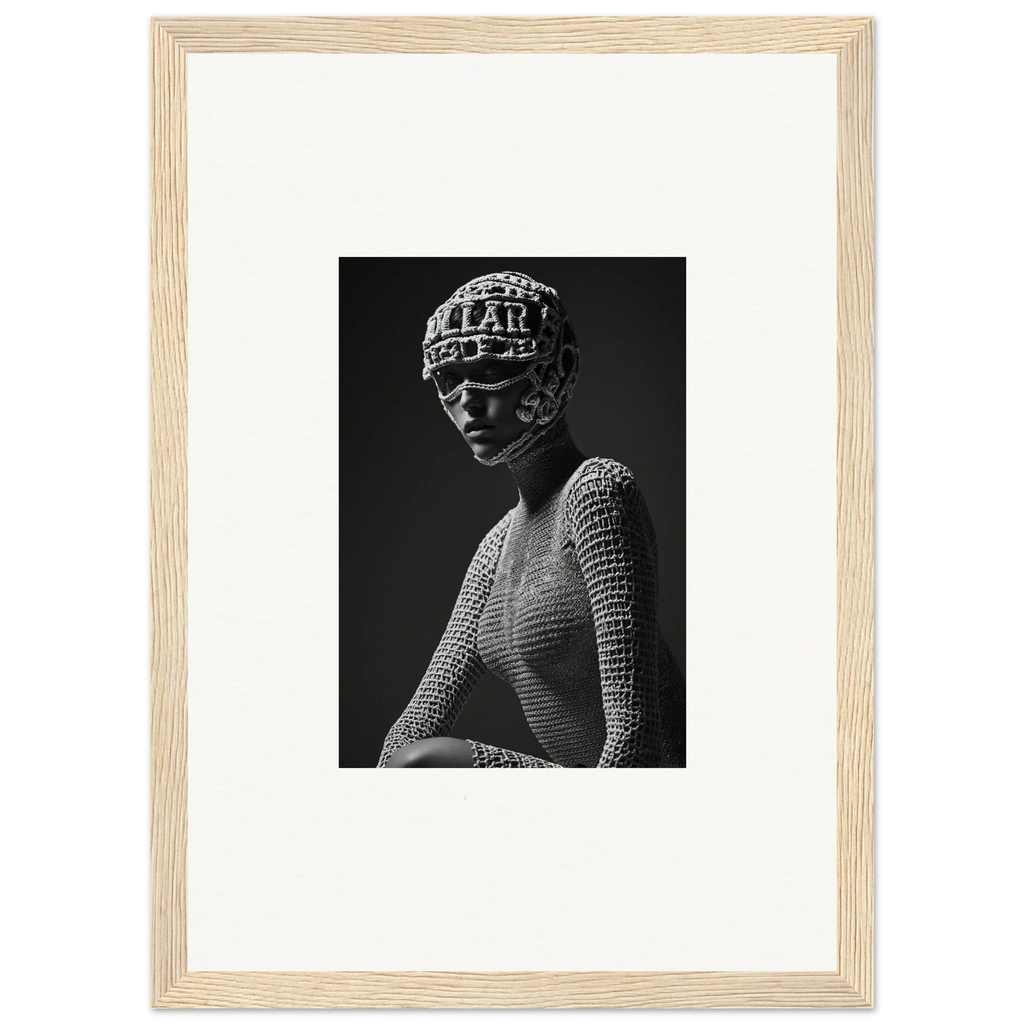 Black and white photograph of a sculptural bust wearing an ornate headdress and textured garment.