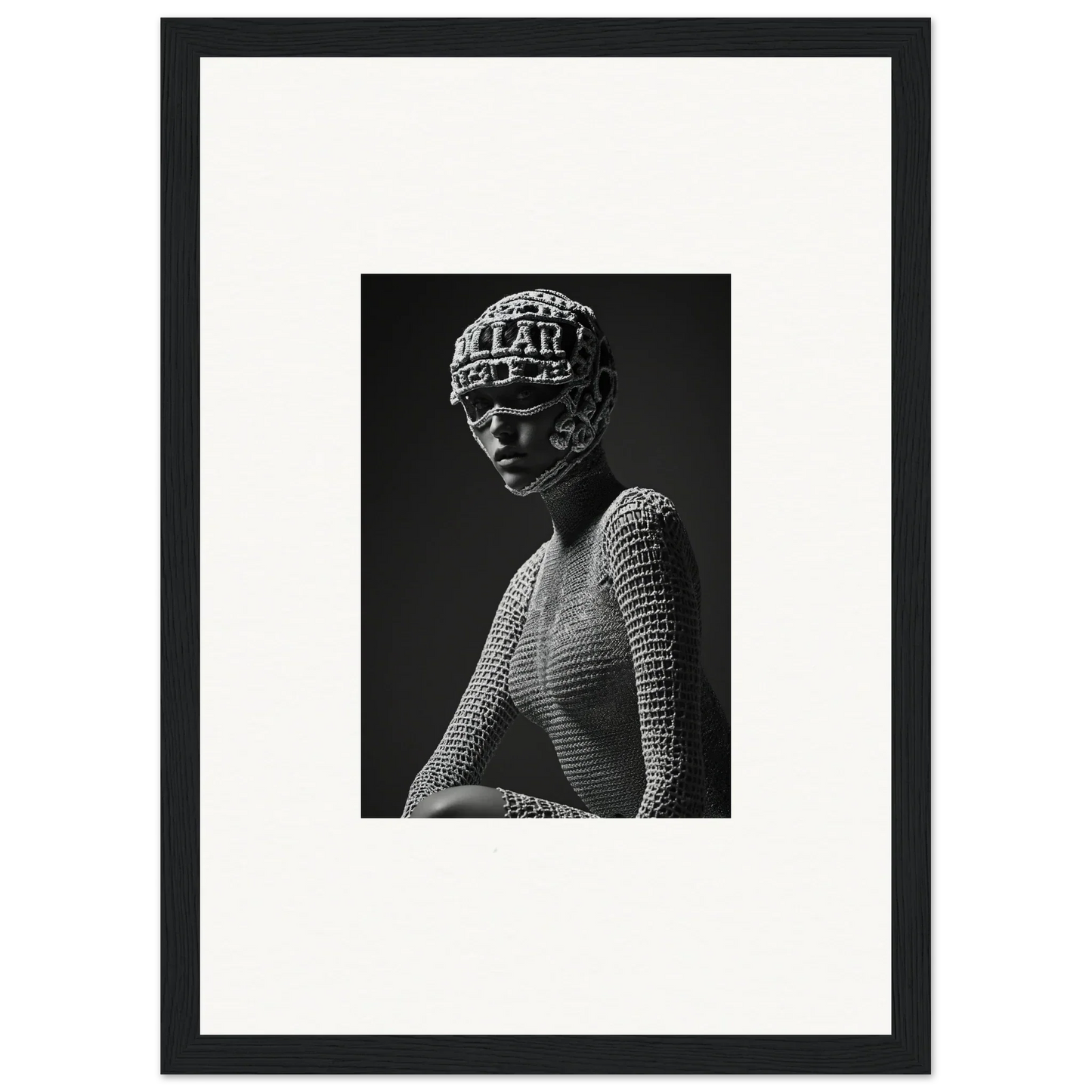 Black and white photograph of a figure wearing an ornate headdress and textured top.