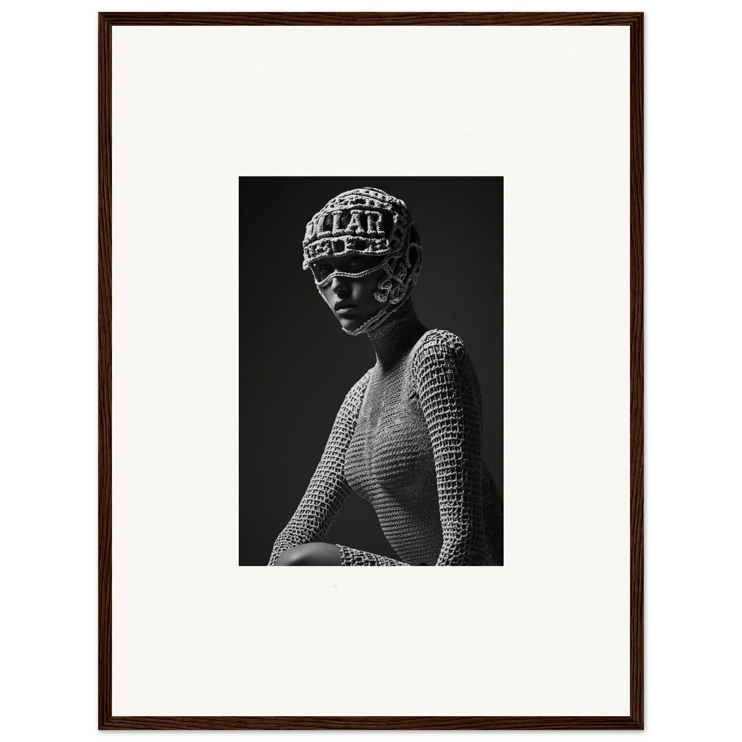 Black and white photograph of a figure wearing a textured headpiece and mesh top.