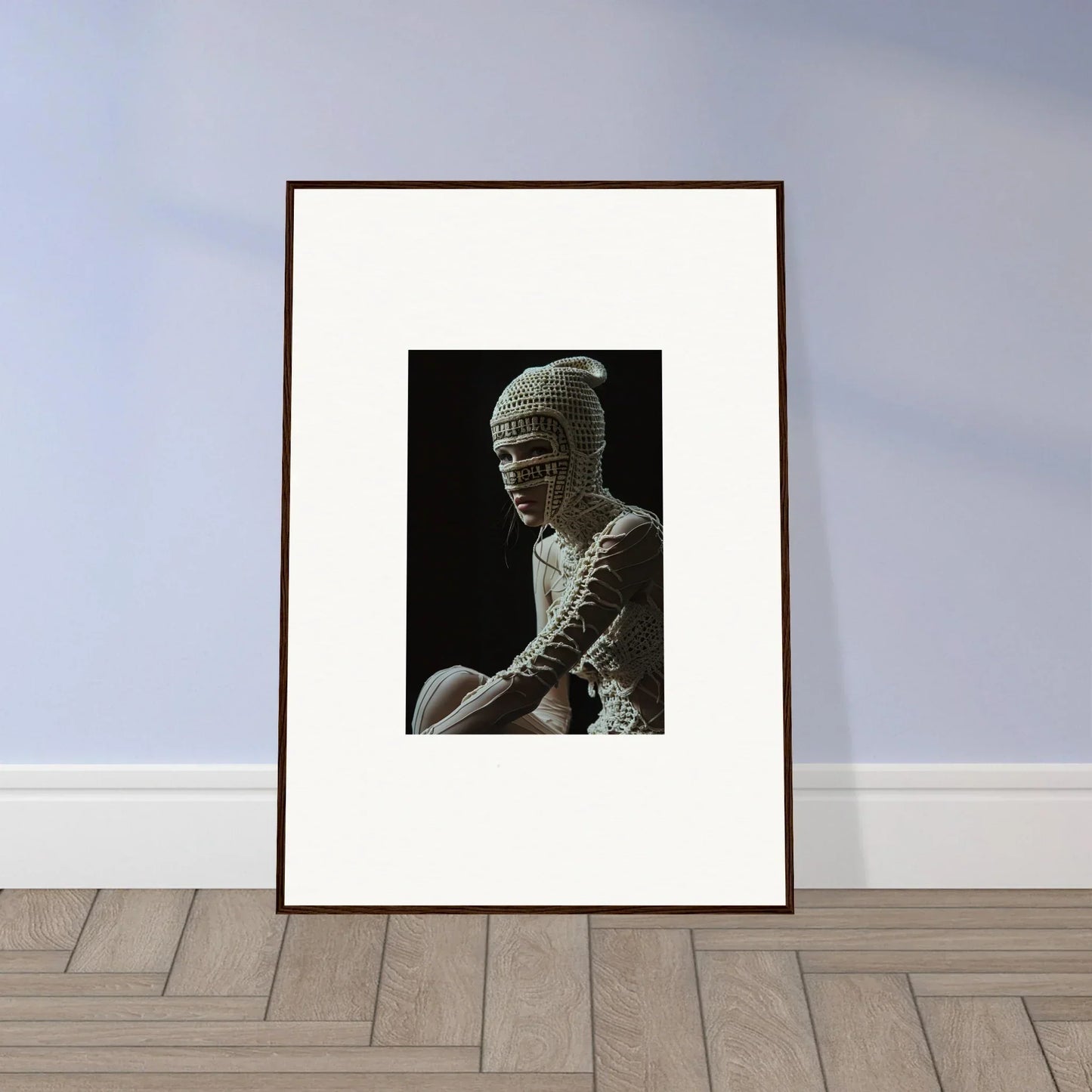 Framed black and white photograph of a person wearing a textured headpiece.