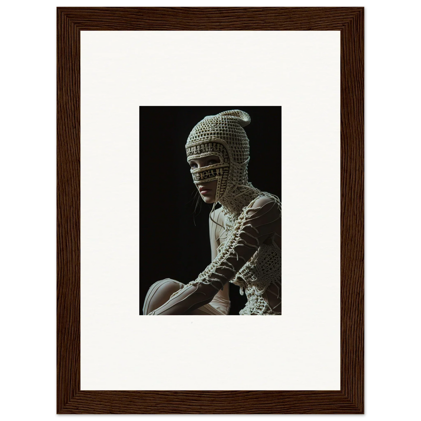 Framed photograph of a sculpture depicting a figure wearing an ornate chainmail-like headdress.