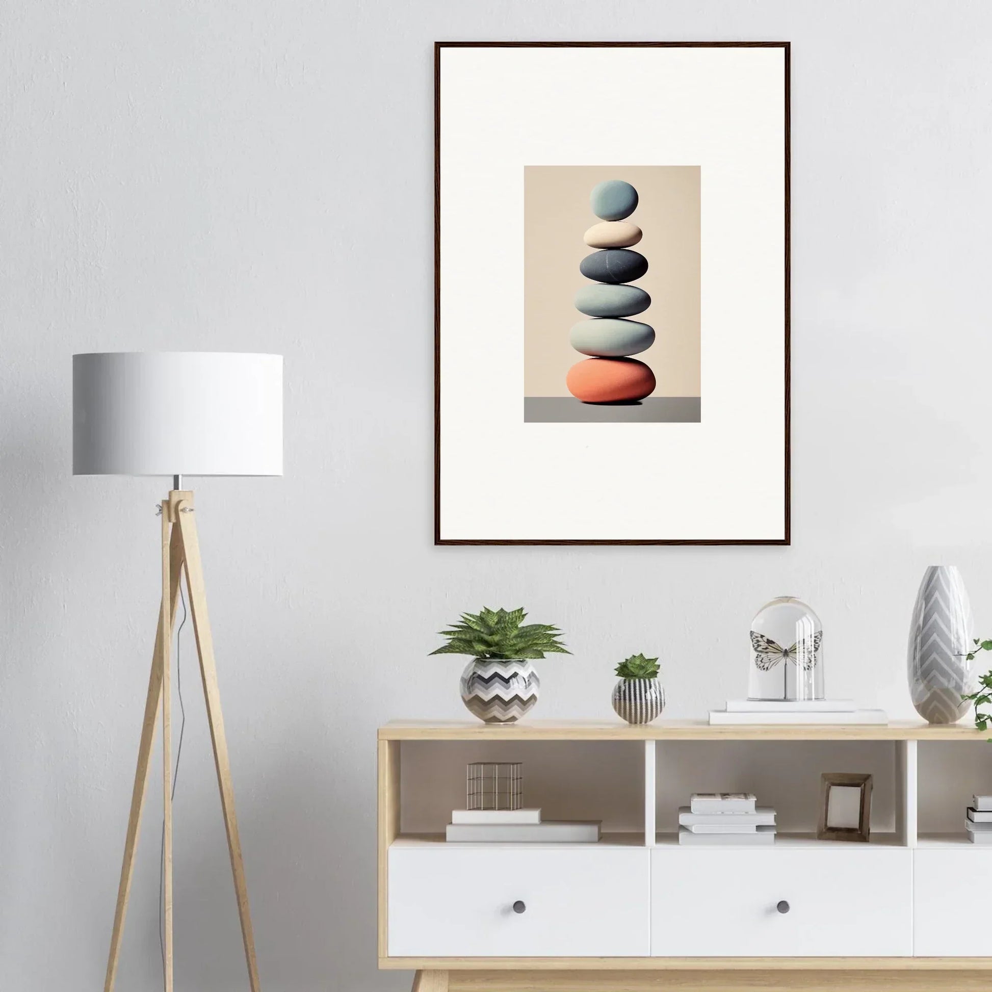 Framed canvas print of balanced stones with an orange base for stylish room decoration