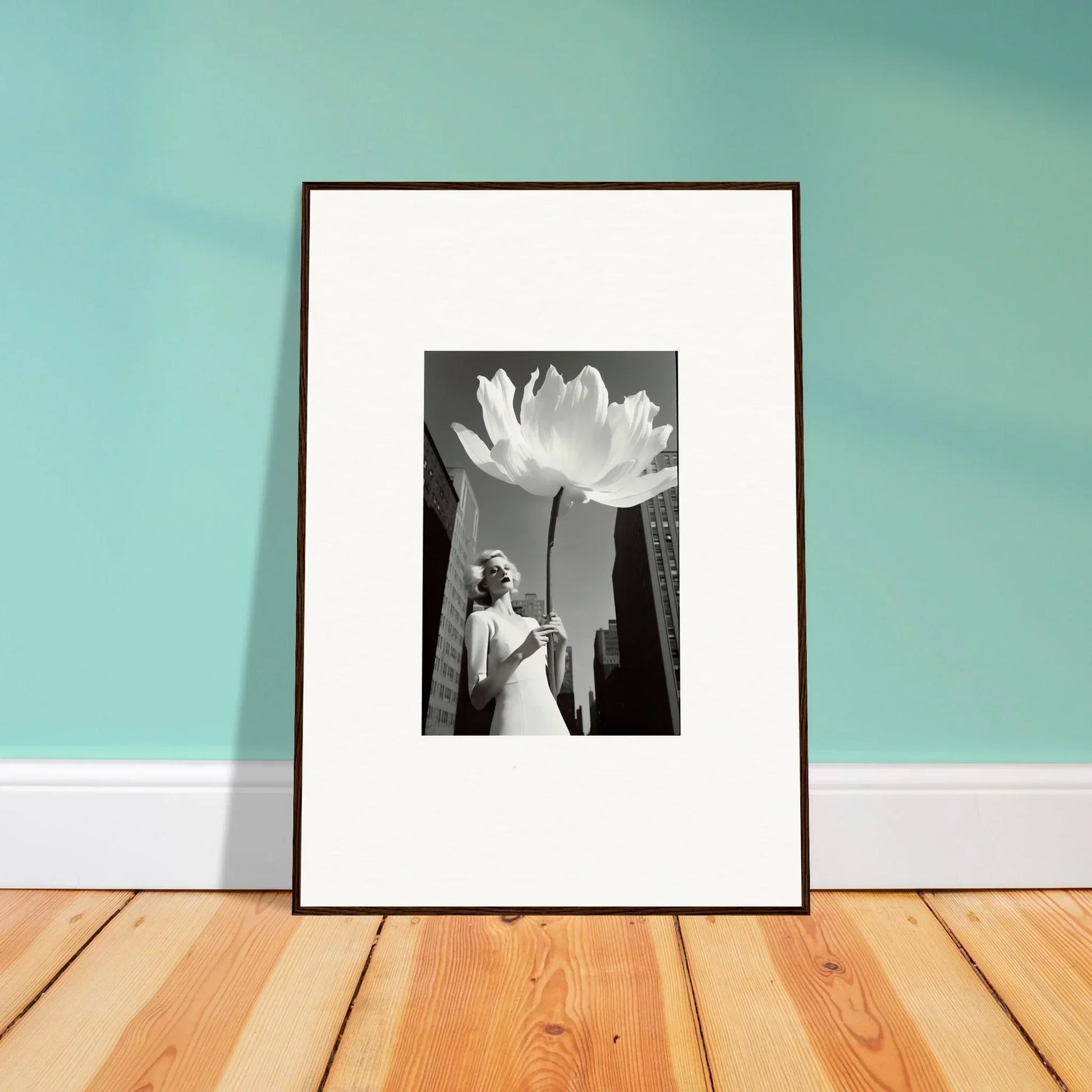 Framed black and white canvas print of a person in a white dress beside a giant flower for room decoration