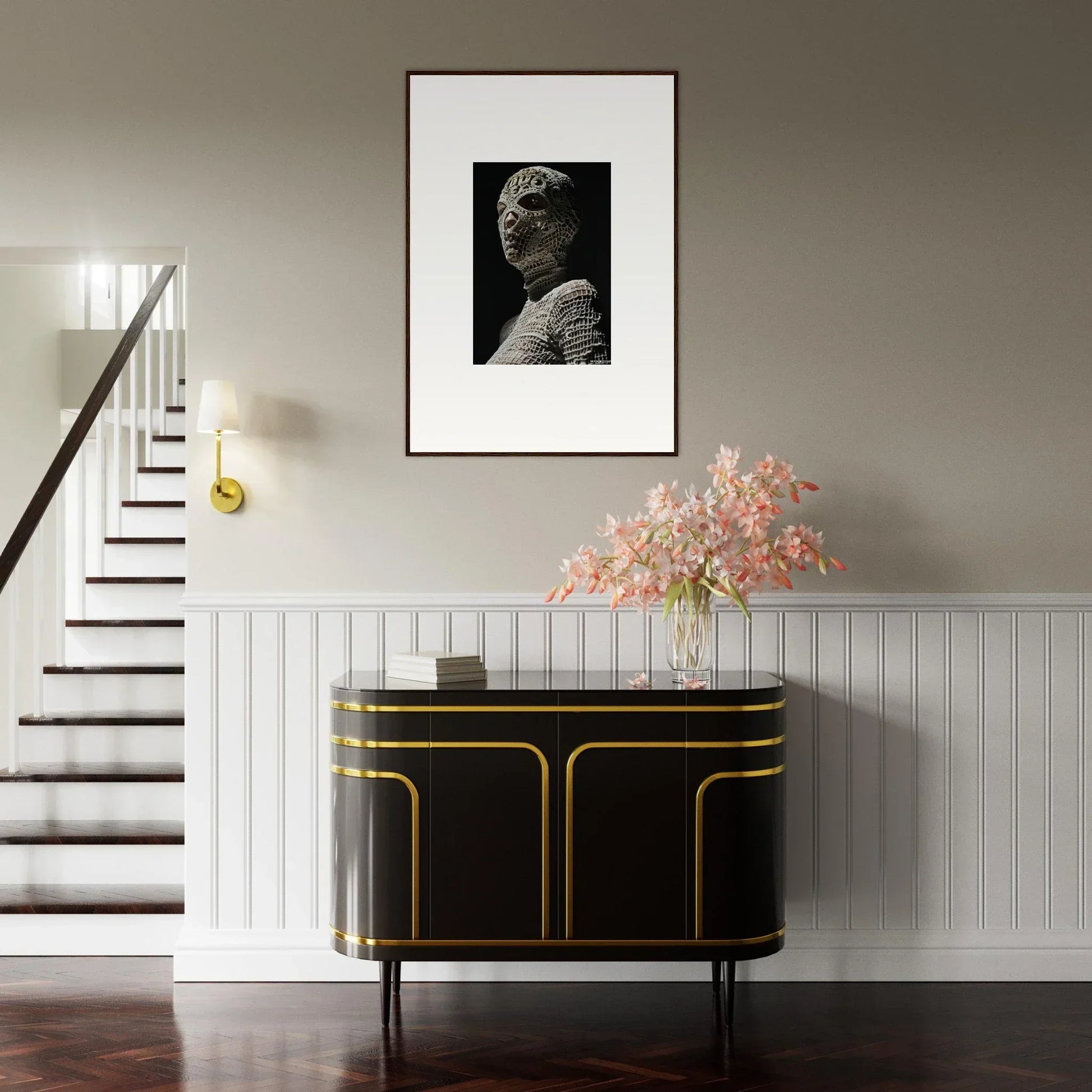 Elegant black and gold sideboard with curved edges beneath a framed portrait and floral arrangement.