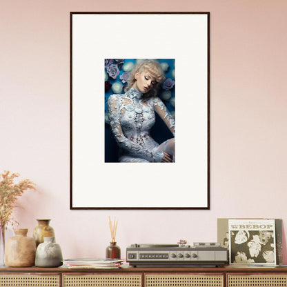 Framed portrait of a woman with blonde hair in a white lace dress surrounded by blue spheres.