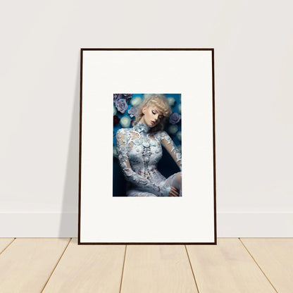 Framed portrait photograph of a blonde woman in an ornate white lace outfit against a blue background with bokeh effects.