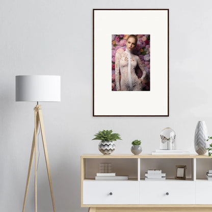 Framed portrait of a woman in a white dress against a floral background.