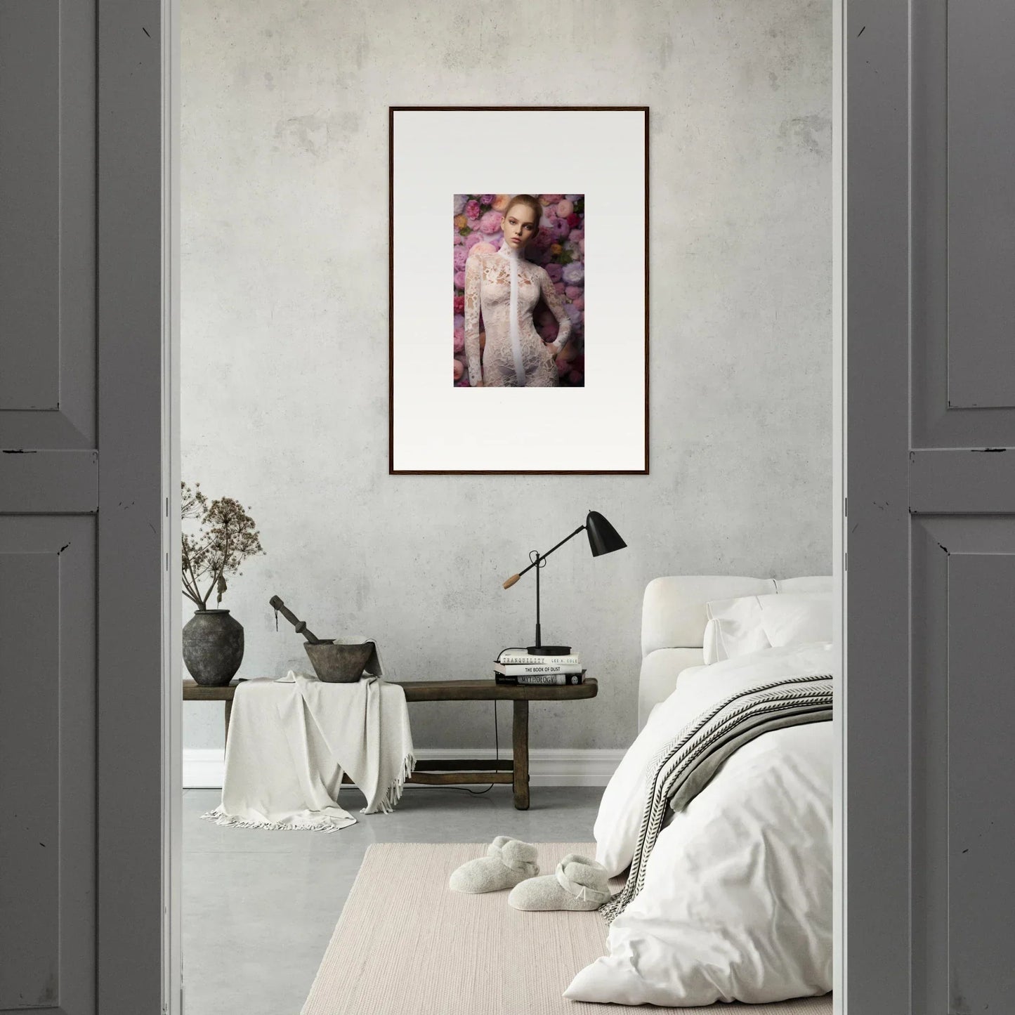 Framed artwork depicting a feminine figure with pink tones hanging on a wall.