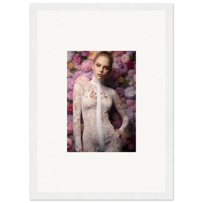 Framed photograph of a woman in a white lace dress against a floral backdrop.