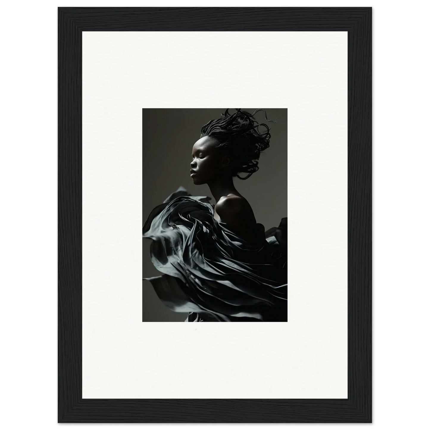 Framed black and white photograph of a person with flowing fabric in motion.