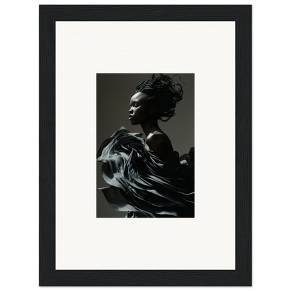 Framed black and white photograph of a person with flowing fabric in motion.