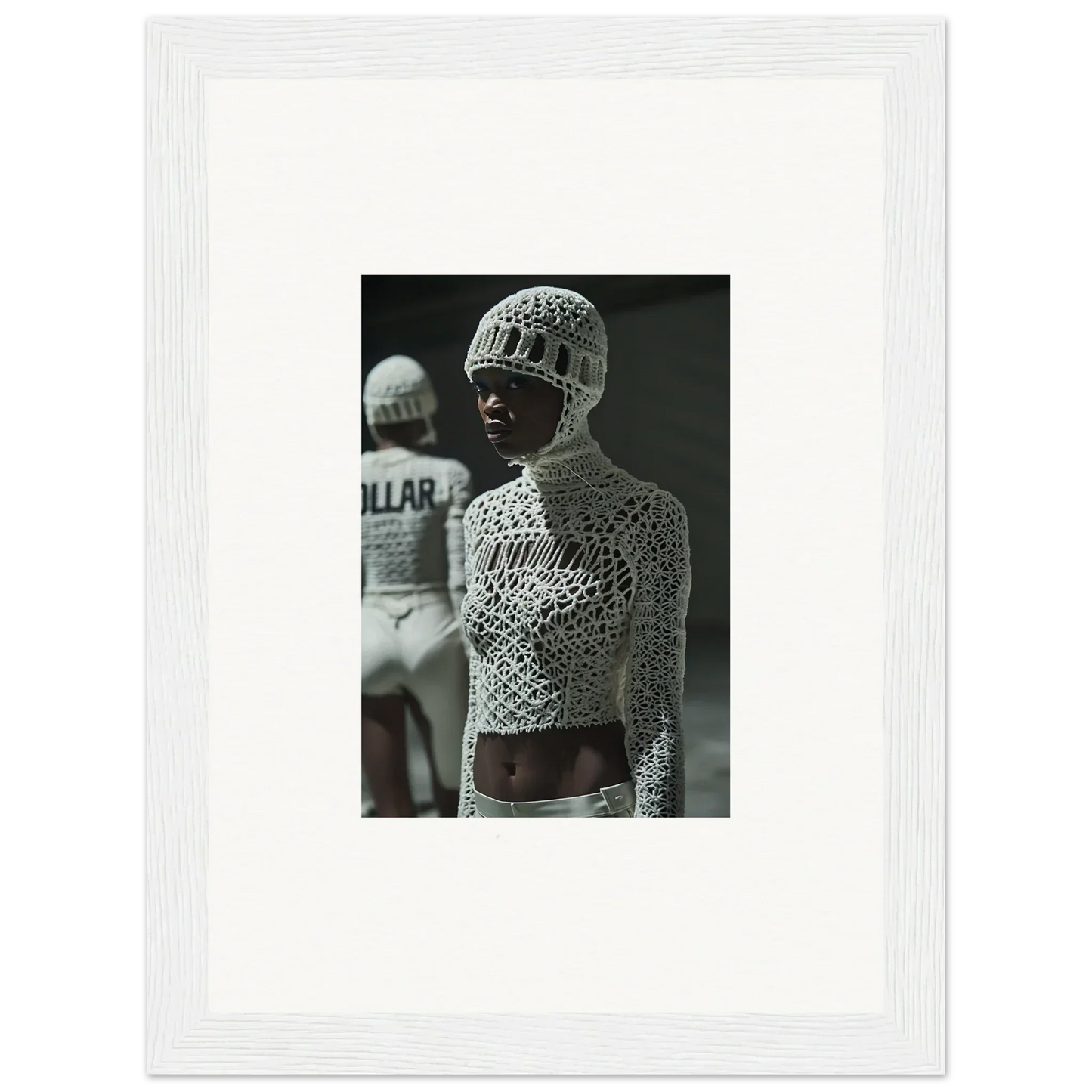 Black and white photograph of a person wearing an intricately patterned bodysuit and headpiece.