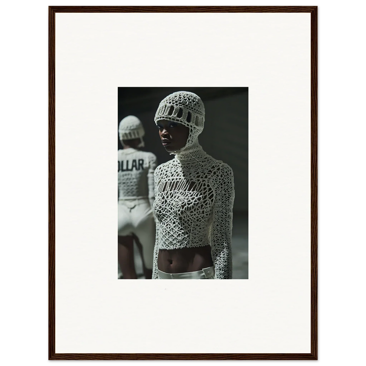 Black and white photograph of a person wearing an intricate crocheted top and hat.