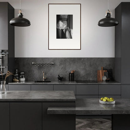 Modern kitchen with dark gray cabinetry and countertops.