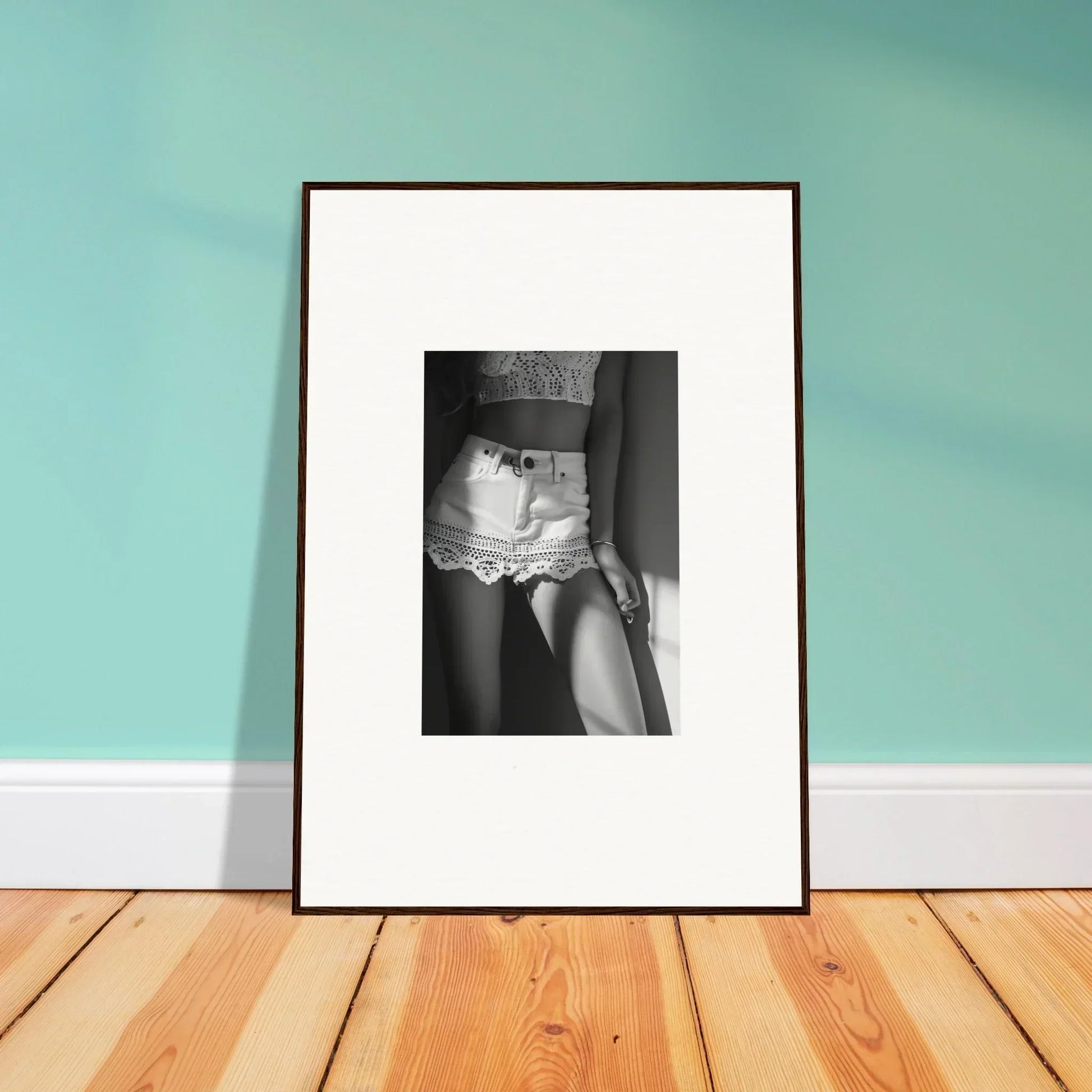 Framed black and white photograph of a person wearing lacy shorts.