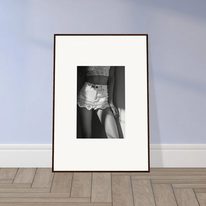 Framed black and white photograph showing a partial view of a person wearing lace underwear.