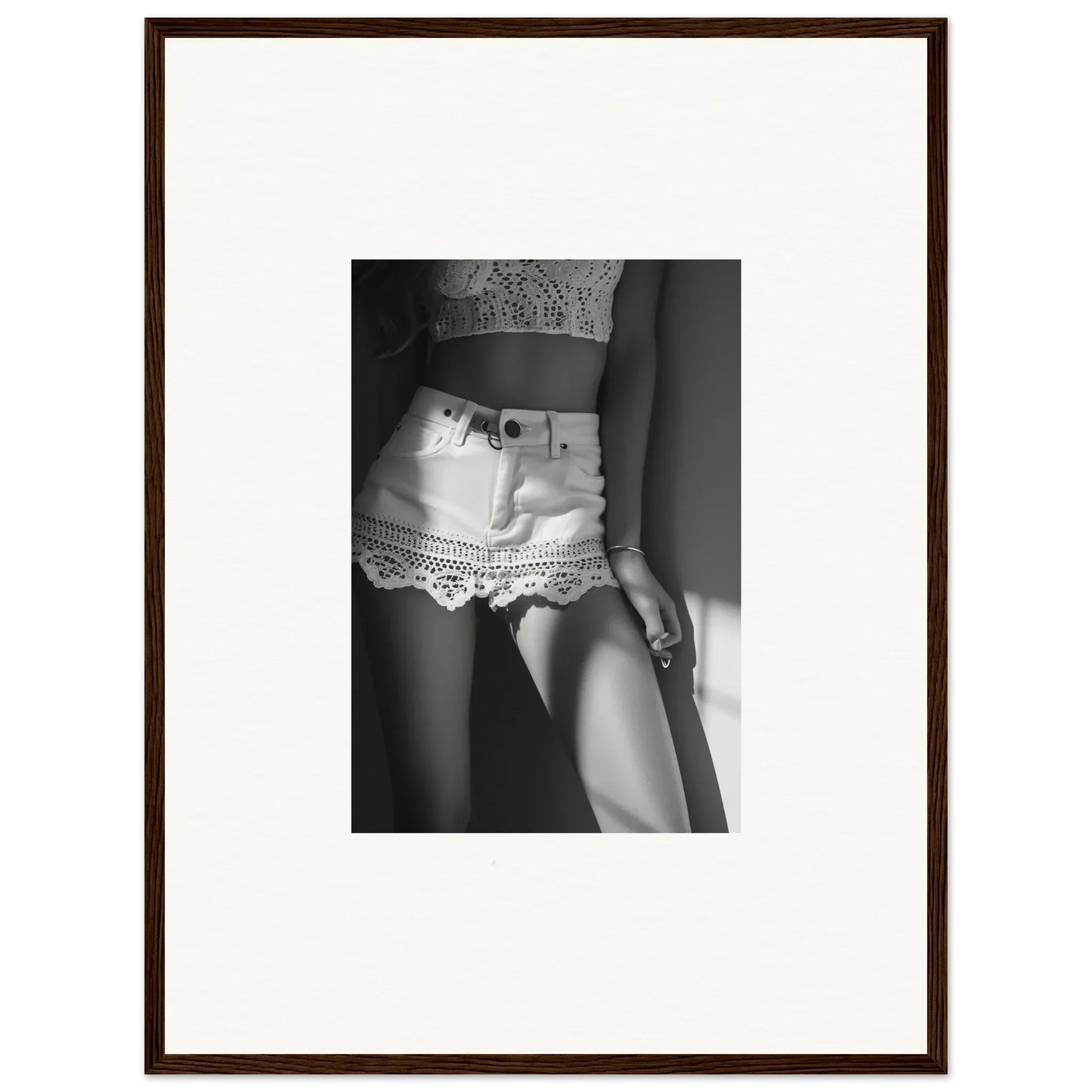 Black and white photograph of a woman’s midsection wearing short lace shorts.