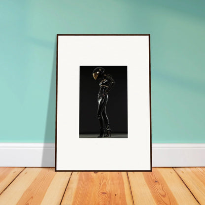 Framed black and white photograph of a person posing dramatically in a full-body suit.