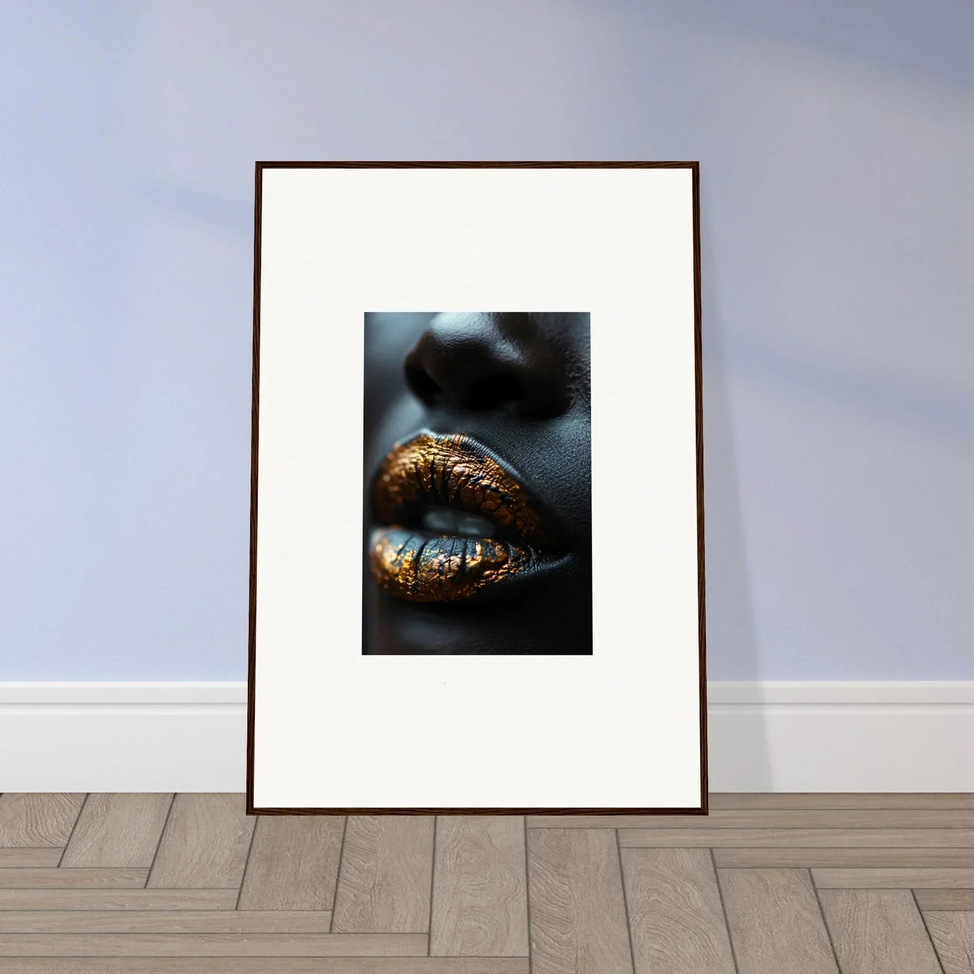 Framed wall art featuring lips adorned with gold metallic makeup in Gilt Glimmer