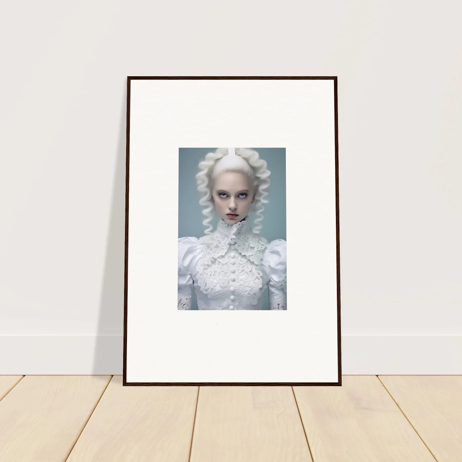 Framed portrait photograph of a pale figure with white hair and dramatic makeup wearing an ornate white high-necked garment.