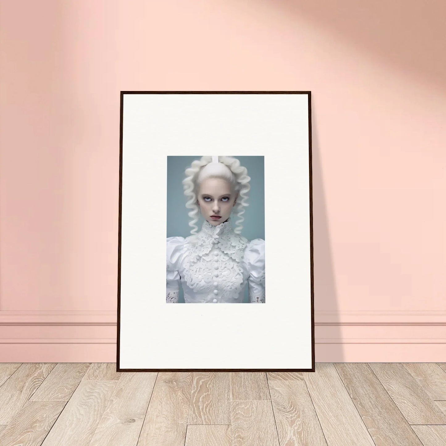 Framed portrait of a person with white hair and makeup wearing an ornate white outfit.