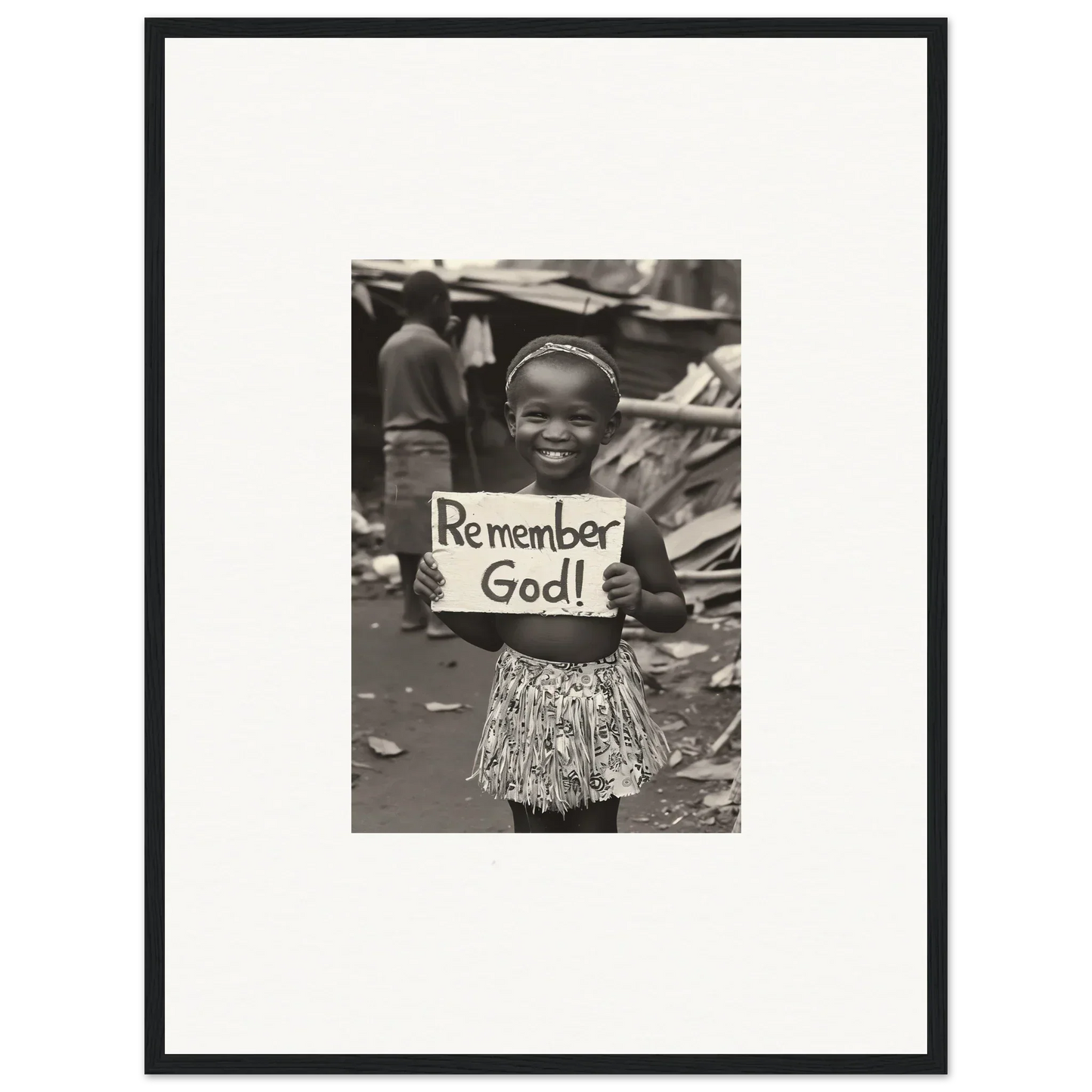 Child holding a Remember God sign in a special edition art™ framed wall art