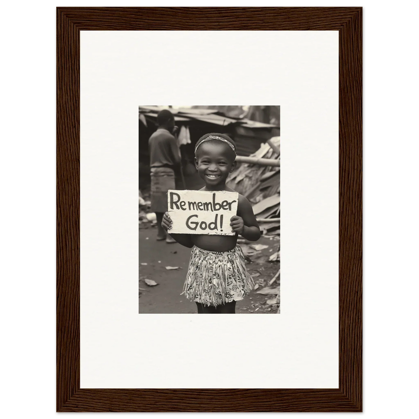 Black and white photo of a child with a Remember God sign in premium framed wall art