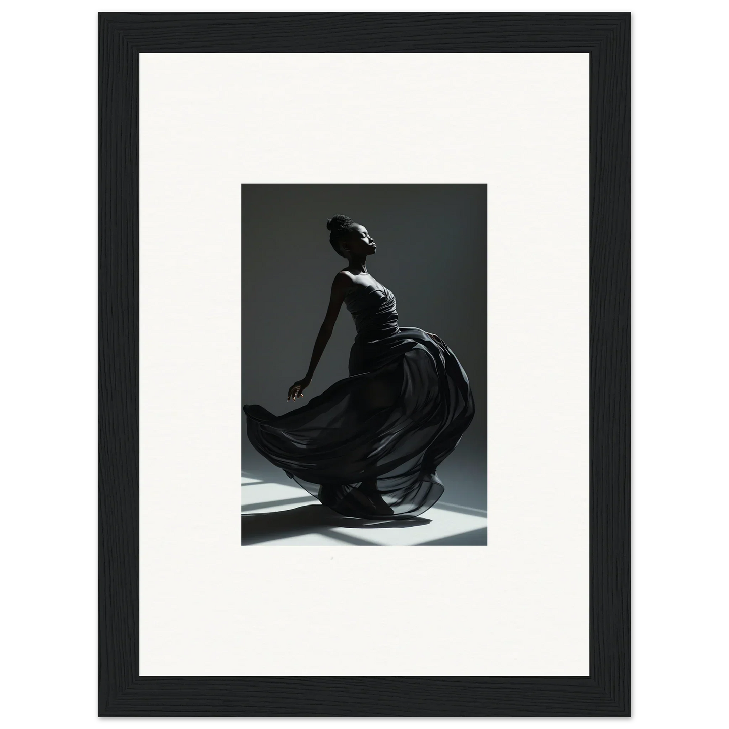 Framed black-and-white photograph of a graceful dancer in a flowing dress.