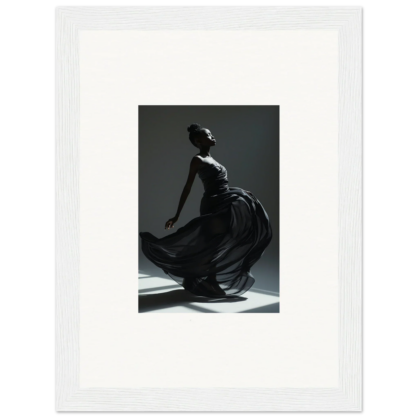 Graceful dancer in a flowing black dress captured mid-movement against a dark background.