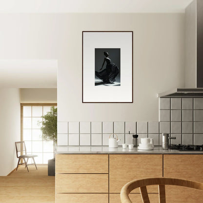 Modern kitchen with wooden cabinets, white tiled backsplash, and framed black-and-white artwork.