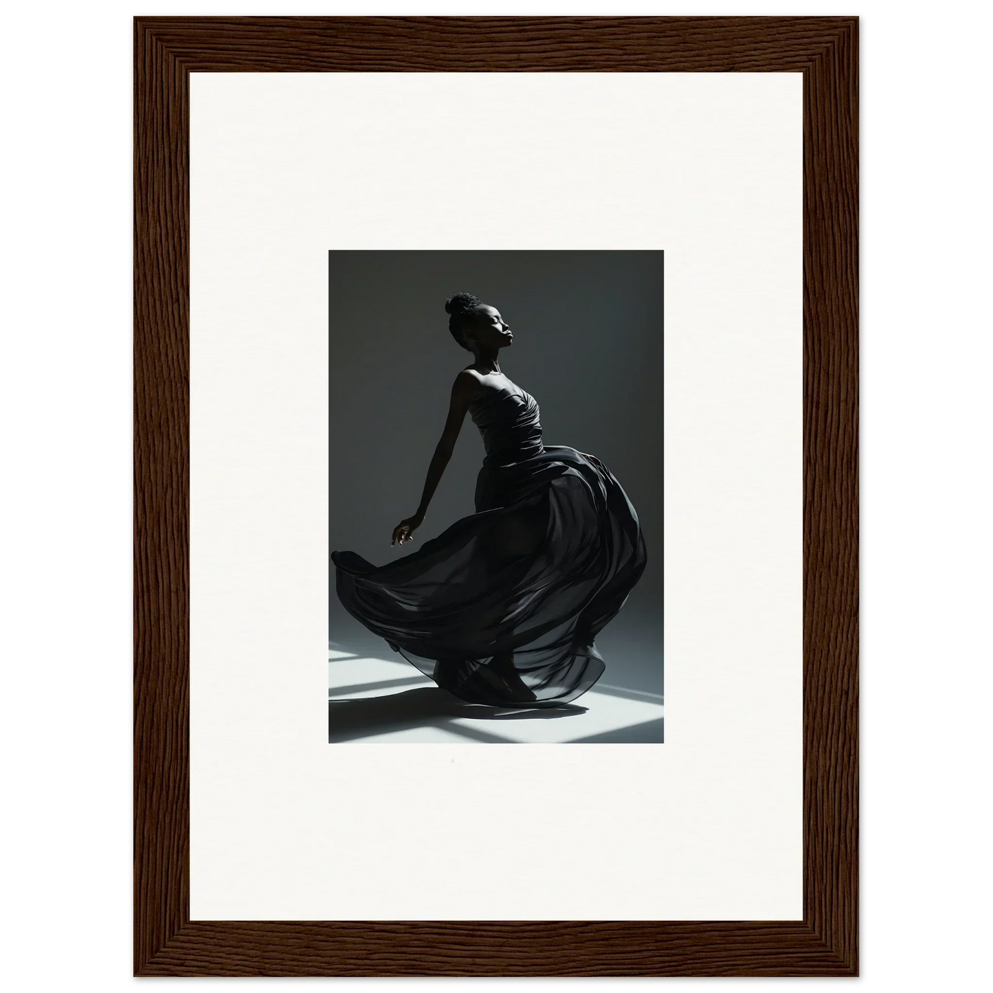 Framed black-and-white photograph of a dancer in a flowing dress, captured mid-movement.