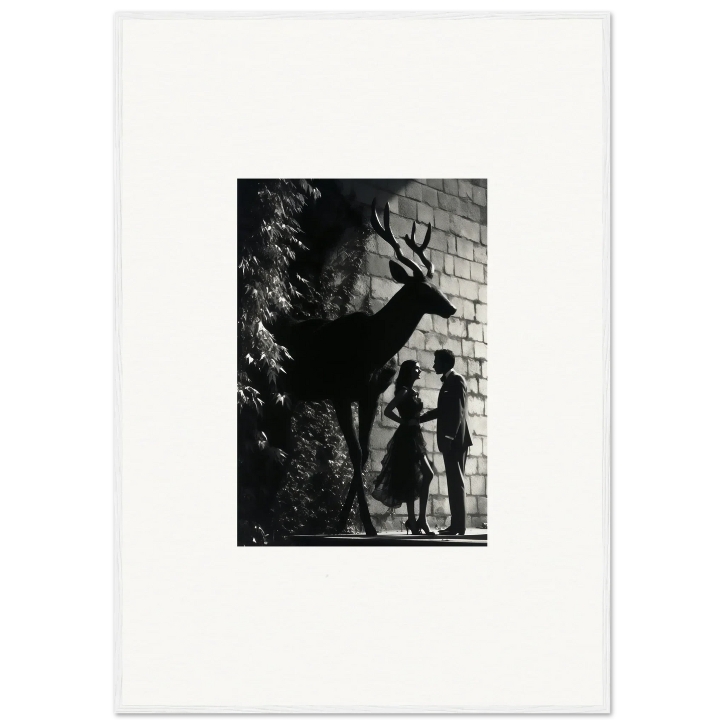 Silhouette of a deer with antlers against a brick wall.