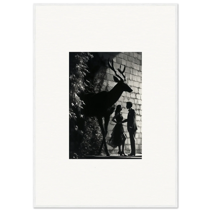 Silhouette of a deer with antlers against a brick wall.