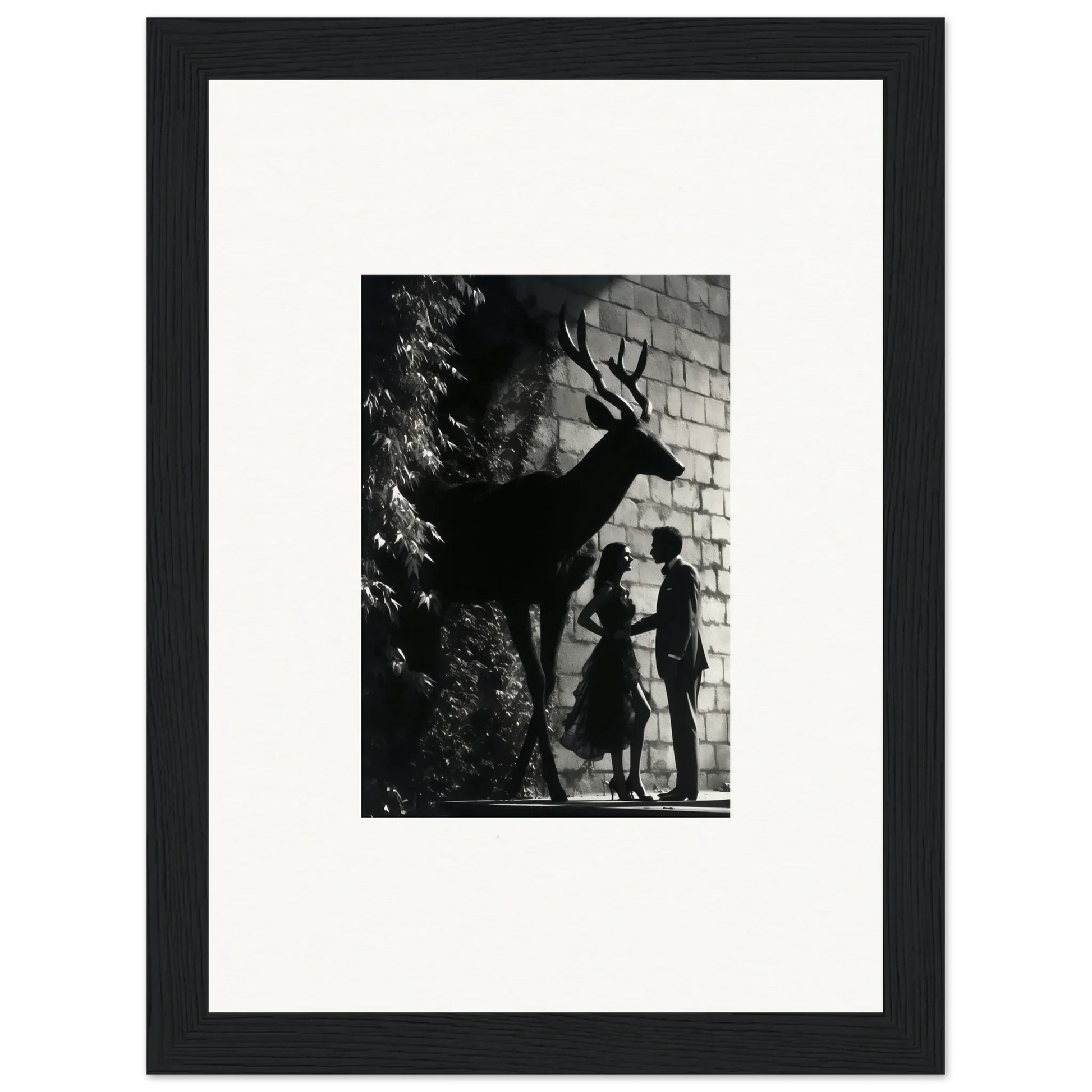 Black and white photograph of a deer’s shadow on a brick wall, with silhouettes of two people beneath it.