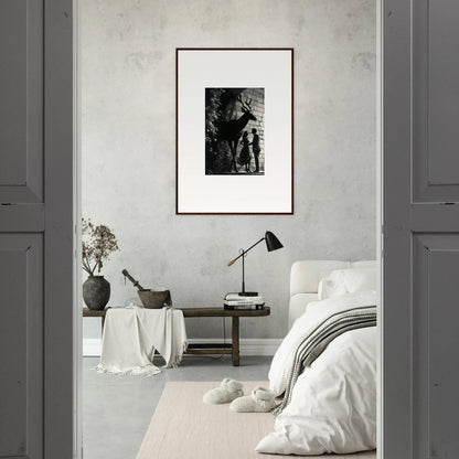 Framed black and white artwork hanging on a light-colored wall.