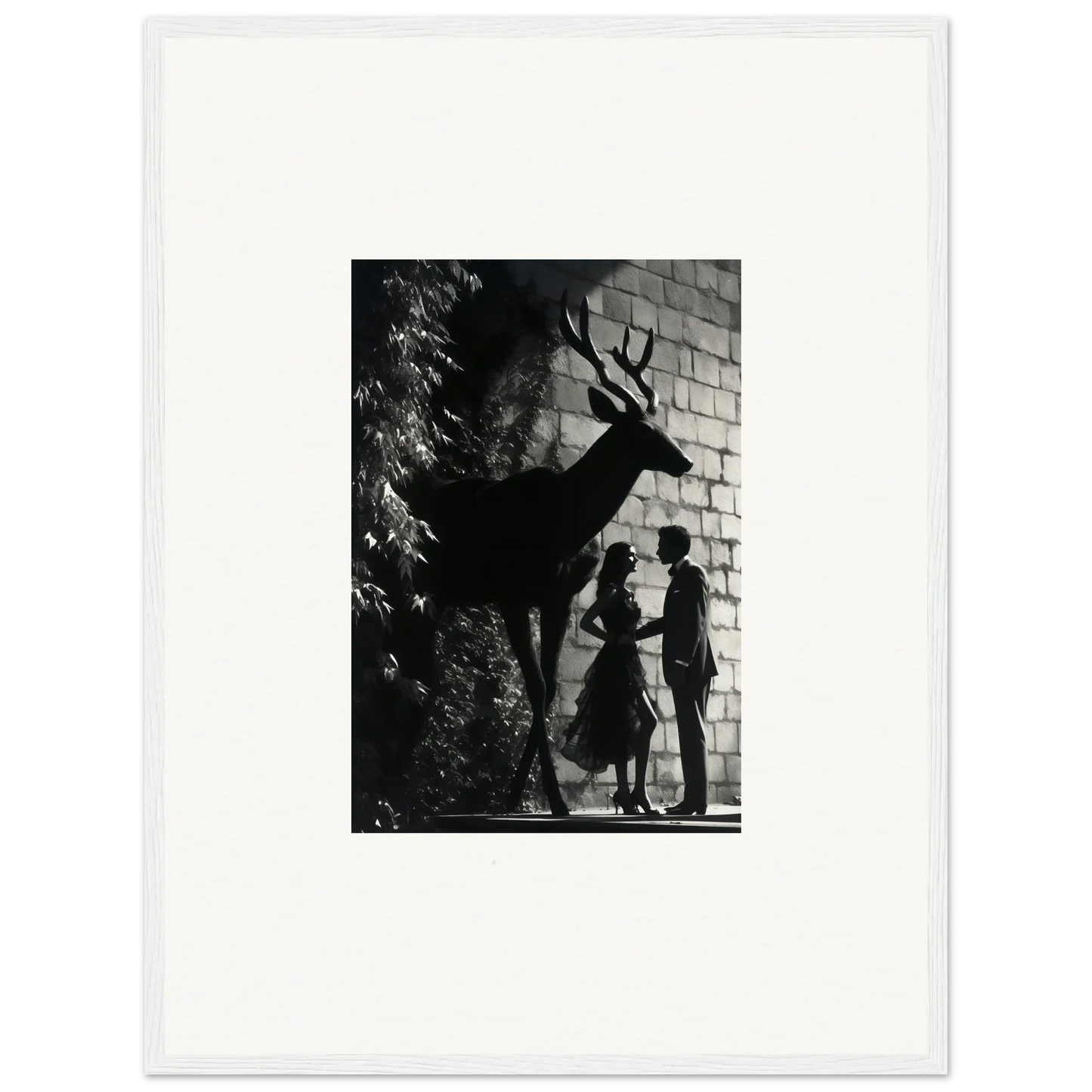 Black and white photograph showing silhouettes of two people and a deer against a brick wall.