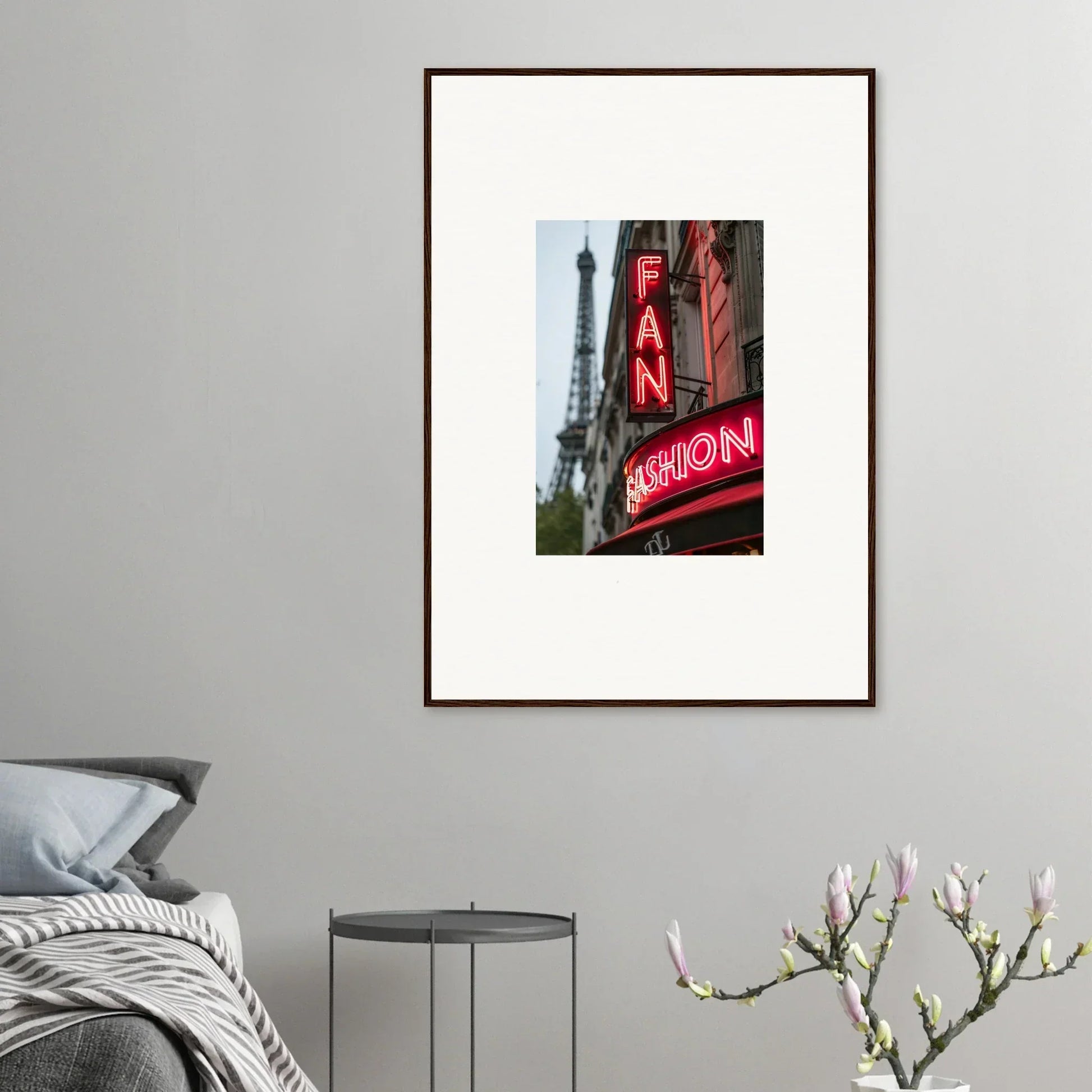 Framed wall art of a Parisian street with a neon FAN sign and the Eiffel Tower