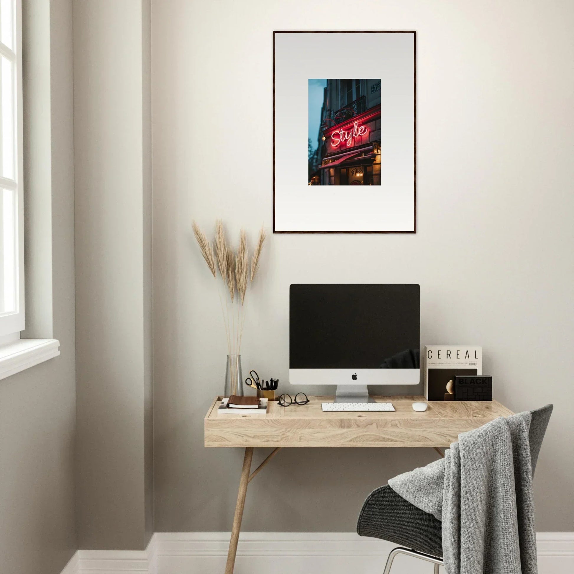 Minimalist wooden desk with computer monitor and Urban Dreaming framed wall art