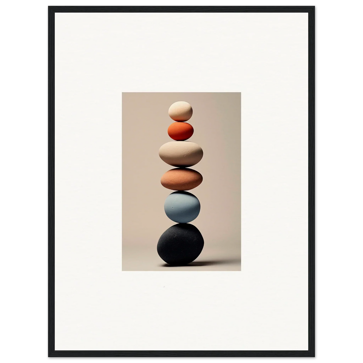 Balanced stack of smooth stones in beige, orange, blue, and black tones for Orb Reverie