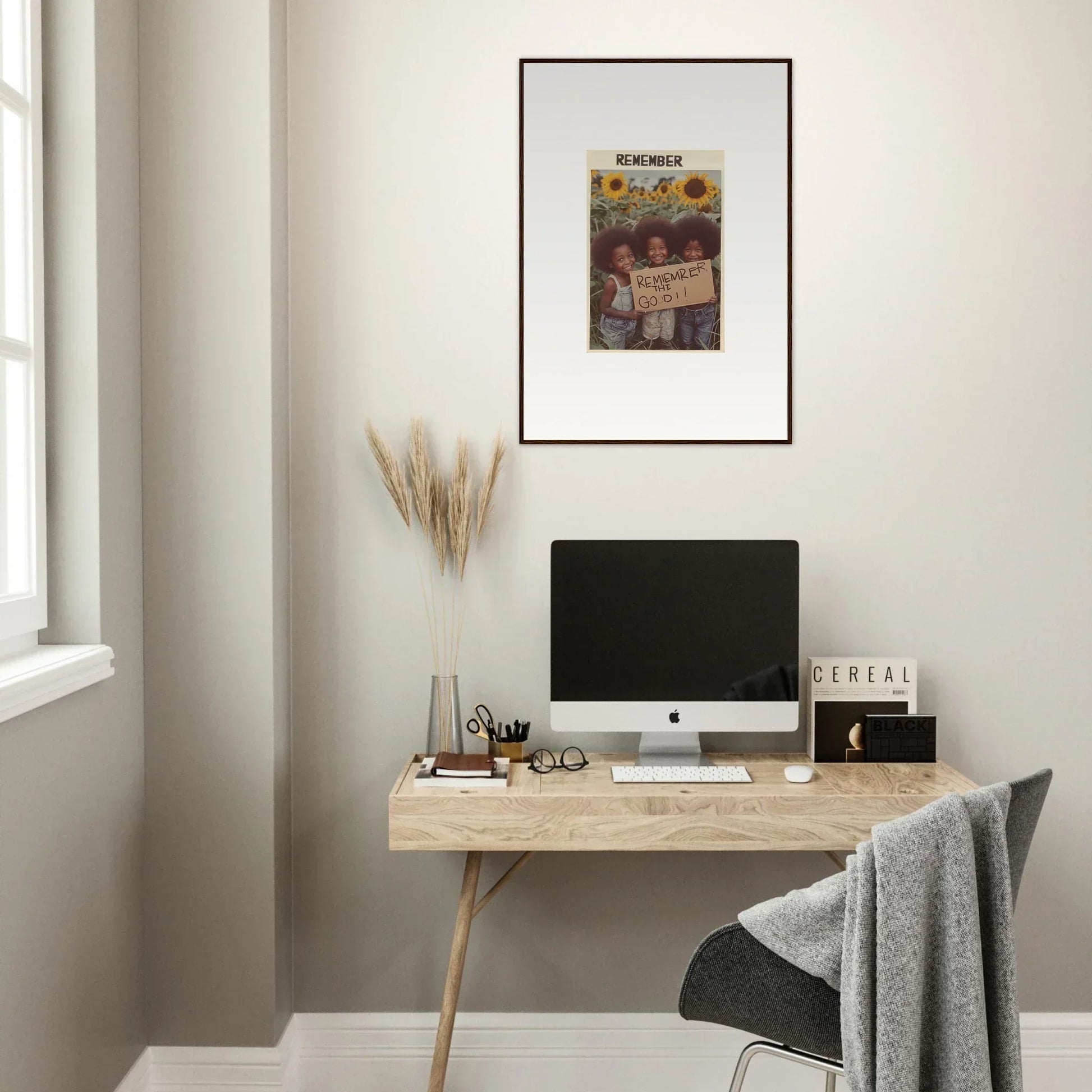 Minimalist wooden desk with a computer and Solar Whimsy canvas print above it