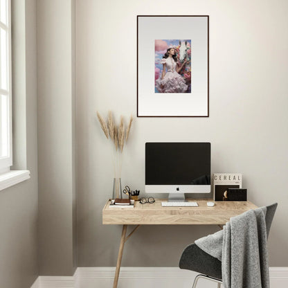 Minimalist home office workspace with a wooden desk, computer, and framed artwork.