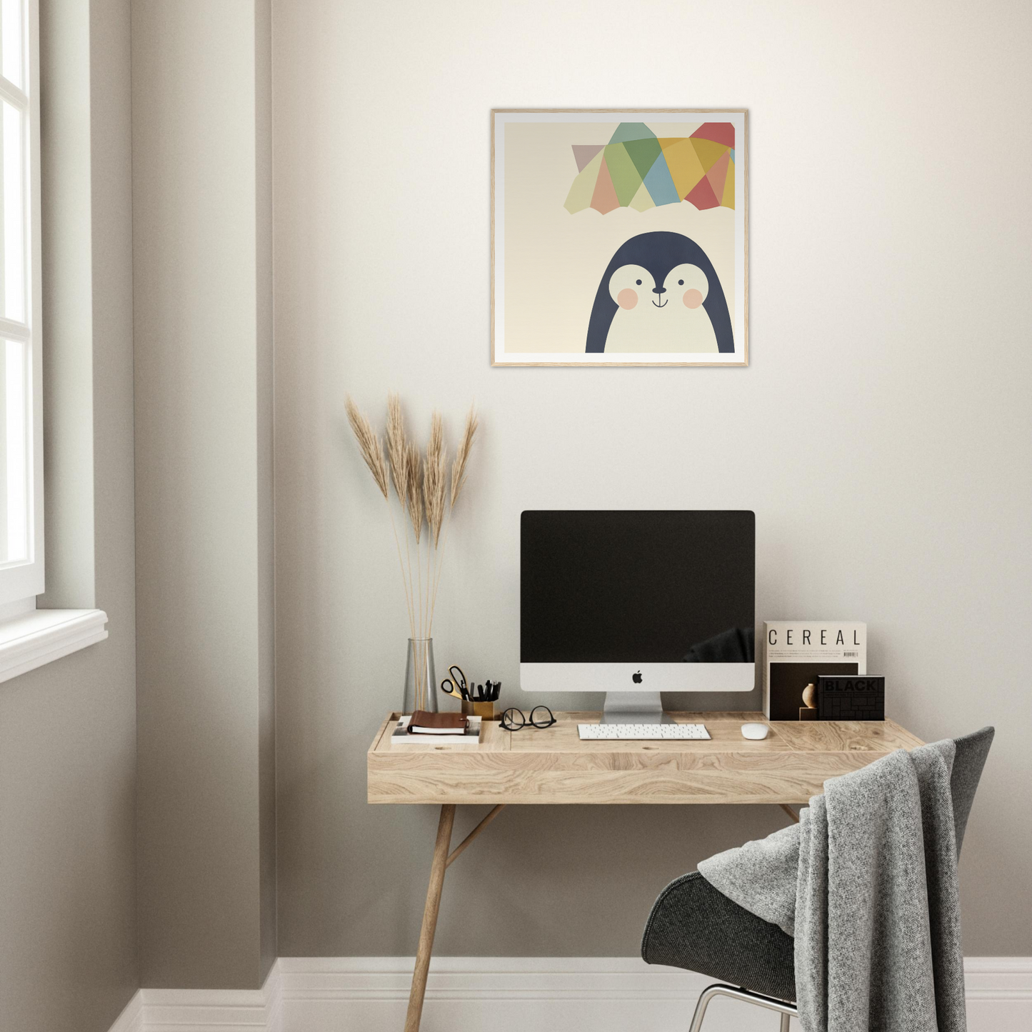 Minimalist wooden desk featuring an iMac and Penguin Prismament decorative artwork