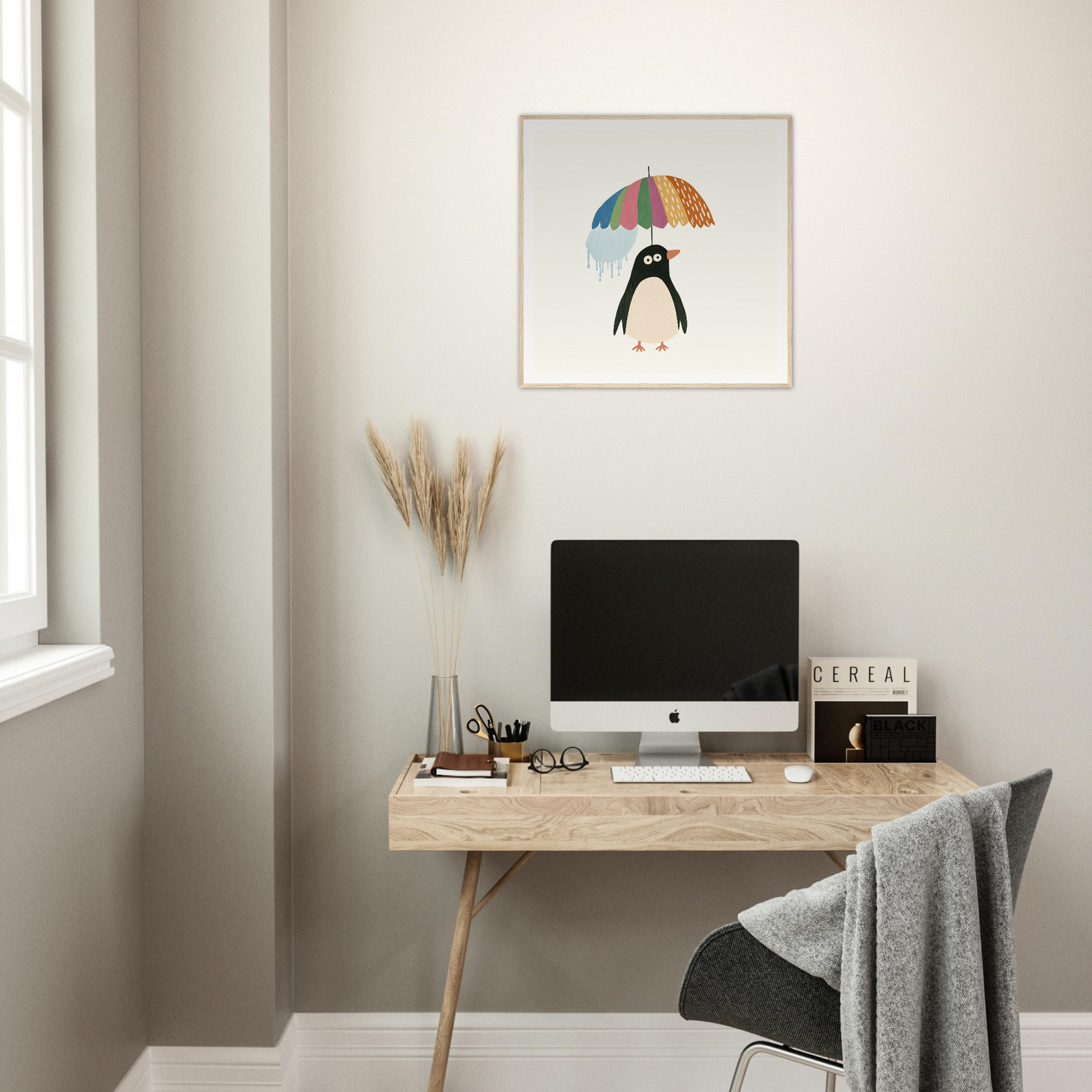 Minimalist wooden desk with iMac and colorful artwork from Penguin Umbrella Revel