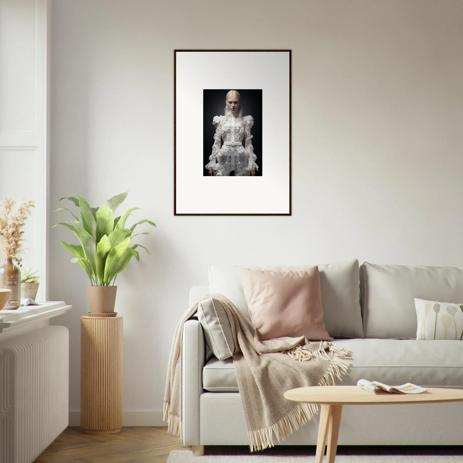 Framed black and white portrait of a person in an elaborate white outfit.