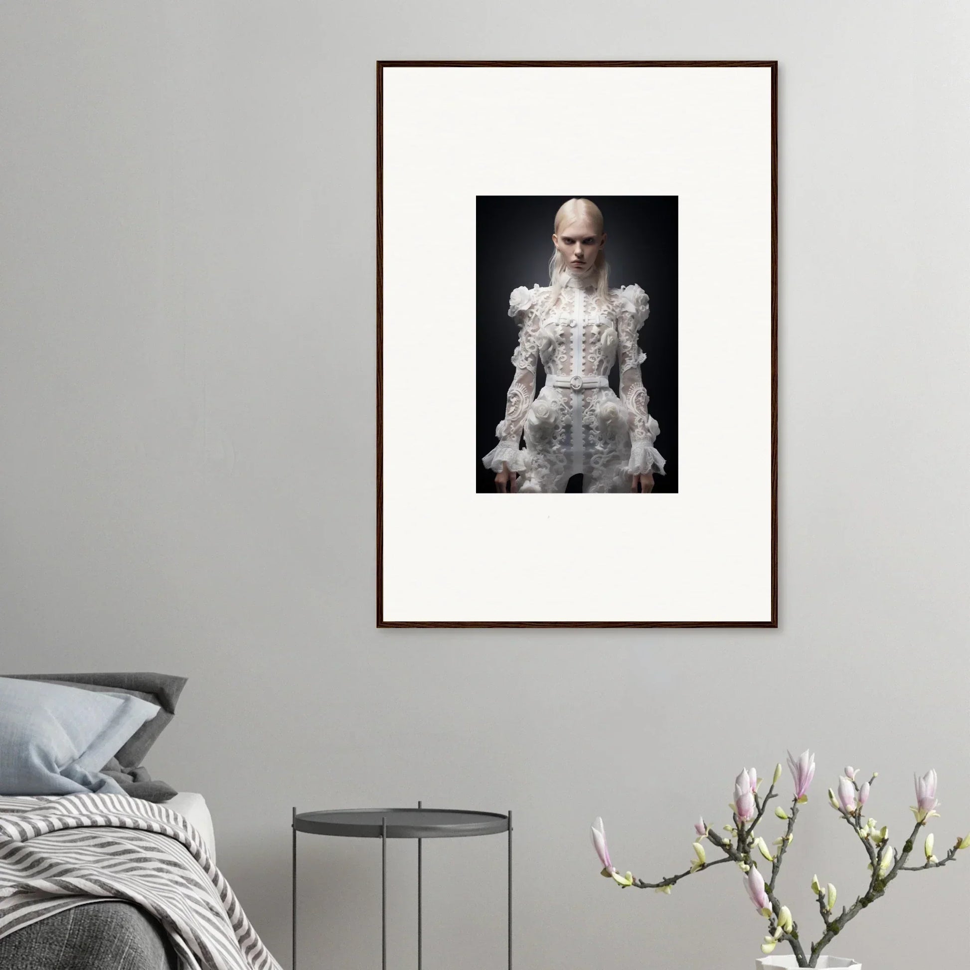 Framed portrait photograph of a person wearing an elaborate white lace dress.