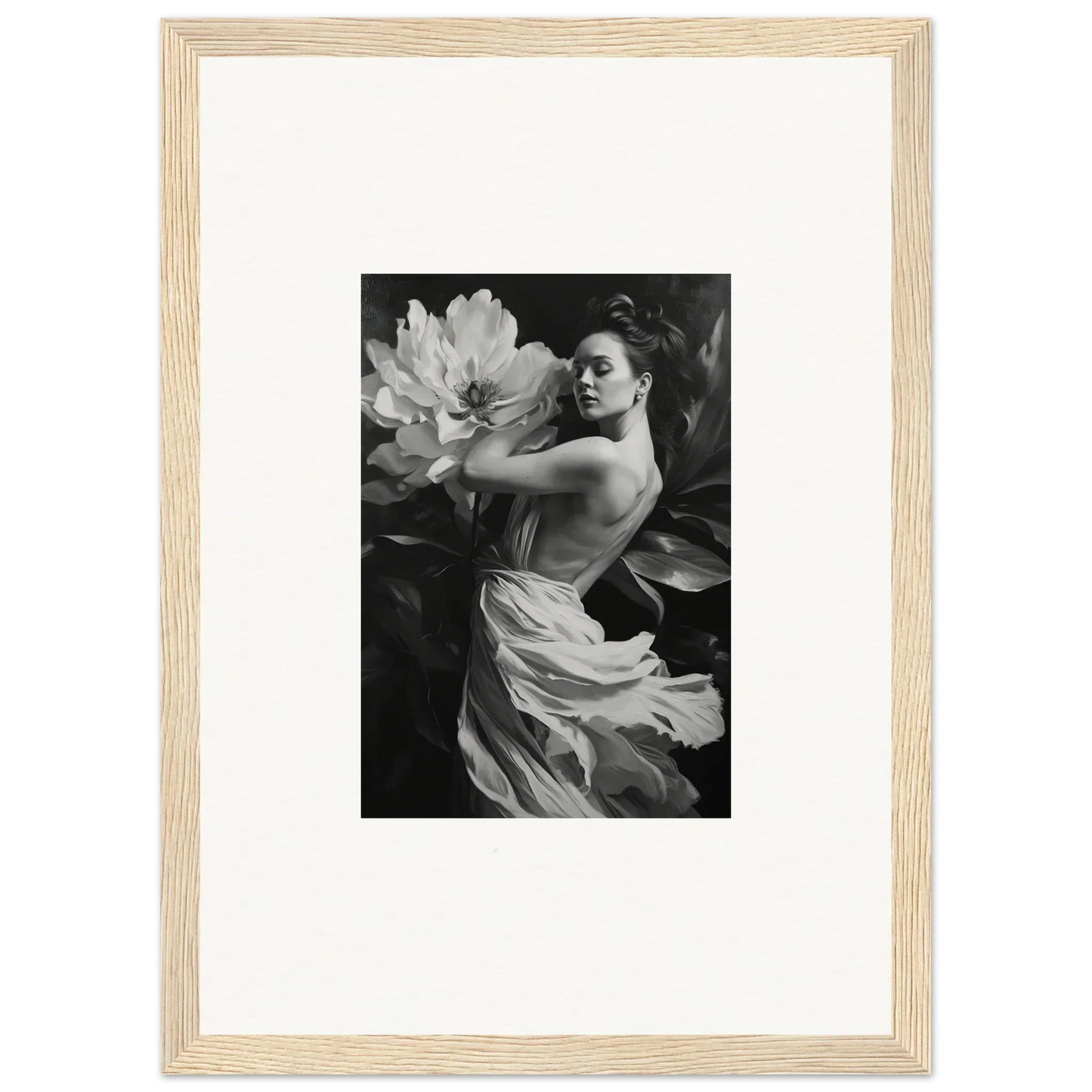 Black and white framed wall art of a woman in flowing fabric with a large flower