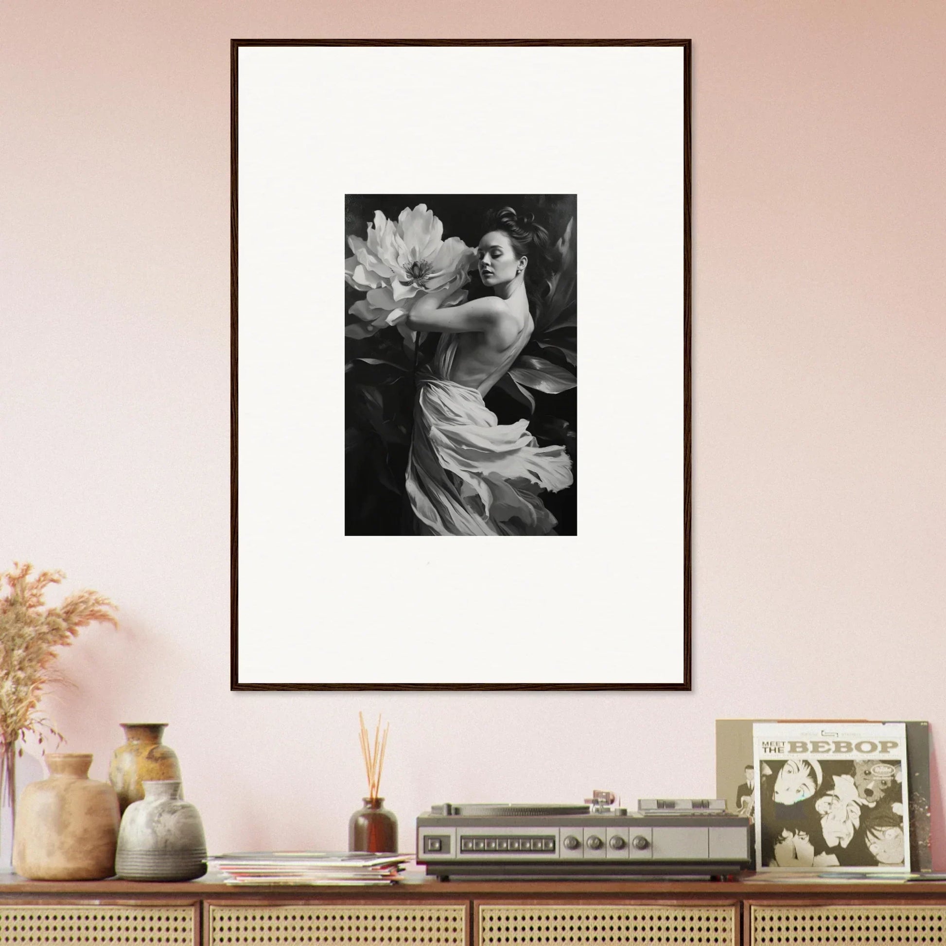 Framed wall art of a person with a large flower enhances your room decor